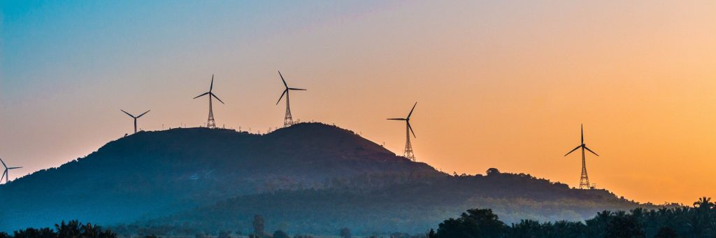 Wind turbines on a hill during sunset